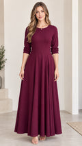 Front view of woman wearing elegant burgundy 3/4 sleeve A-line maxi dress