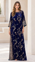Front full-length view of woman wearing navy blue embellished velvet kaftan maxi dress