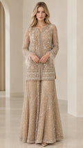 Front view of model wearing champagne embellished long tunic and flared palazzo pant set