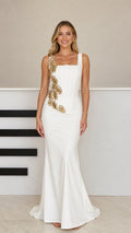 Front full-length view of model wearing white corset square neck mermaid evening gown with gold beaded embellishment
