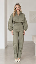 Front full-length view of woman wearing olive green lantern sleeve cargo jumpsuit