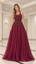 Full front view of model wearing burgundy beaded halter neck A-line evening gown