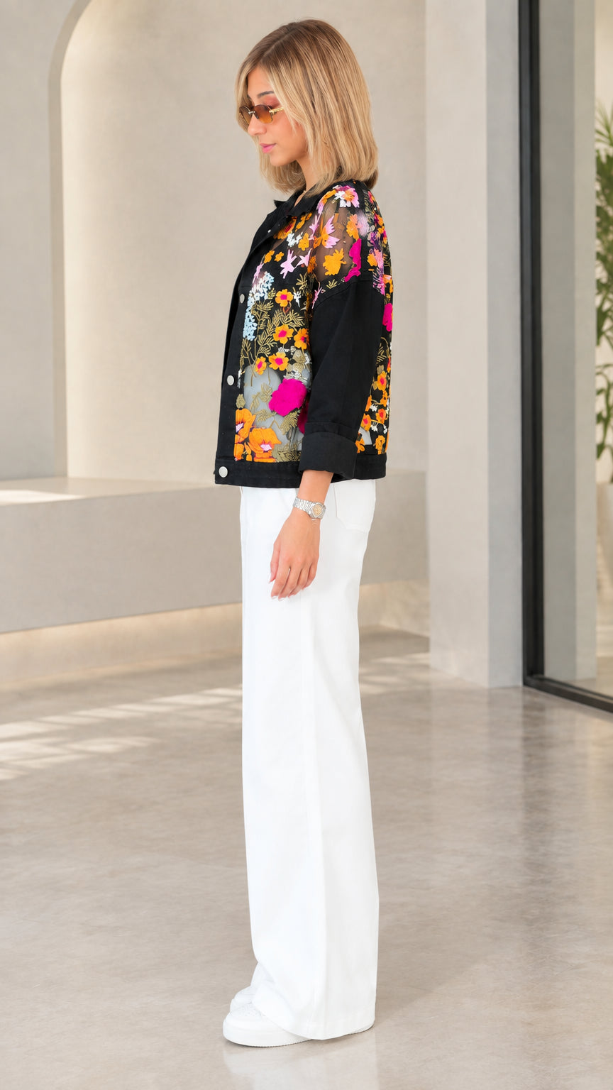 Side view of model wearing black floral embroidered lightweight jacket with solid sleeves