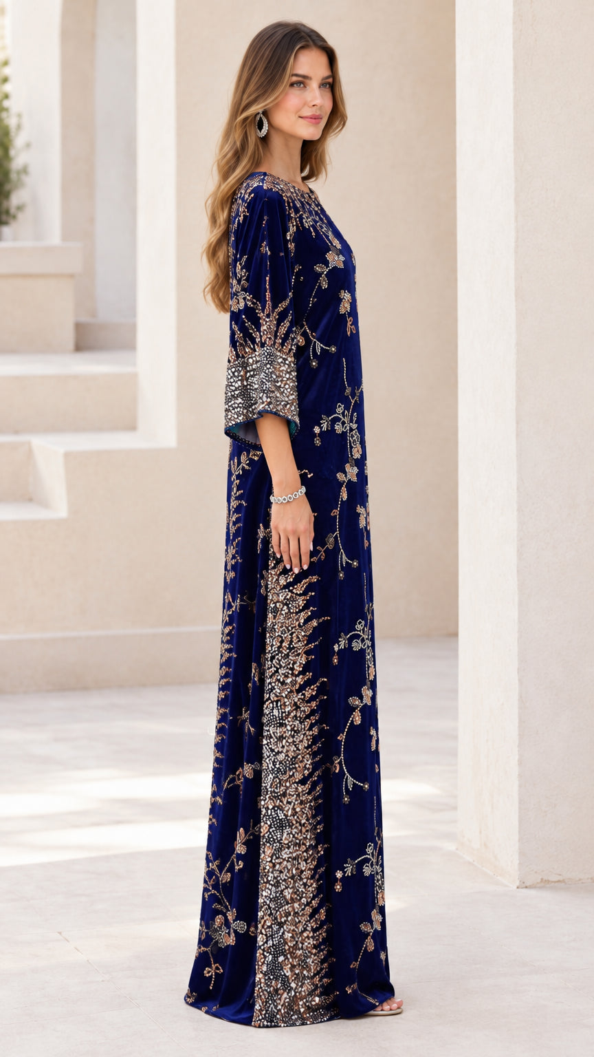 Side profile of woman wearing navy blue beaded velvet evening gown