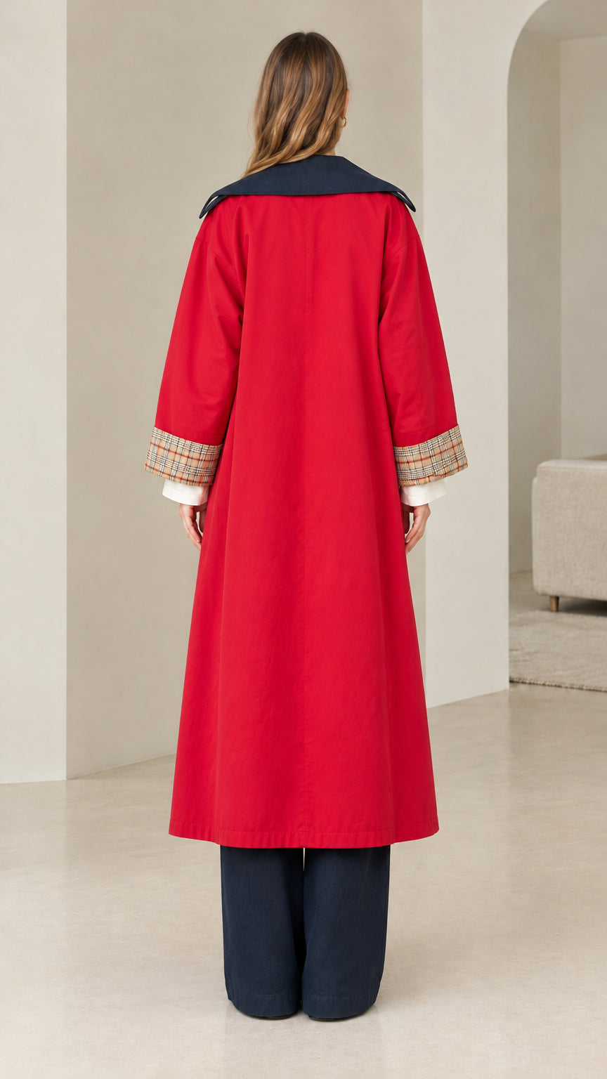 Back view of model in red maxi trench coat with contrast navy collar