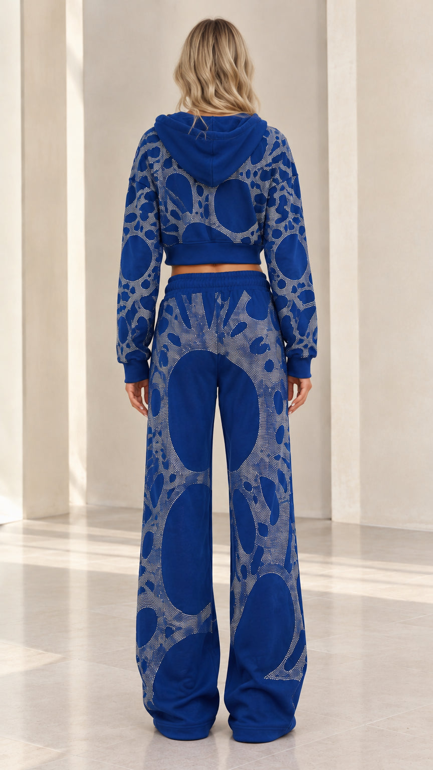 Back view of woman wearing Royal Blue rhinestone embellished hoodie and pants set
