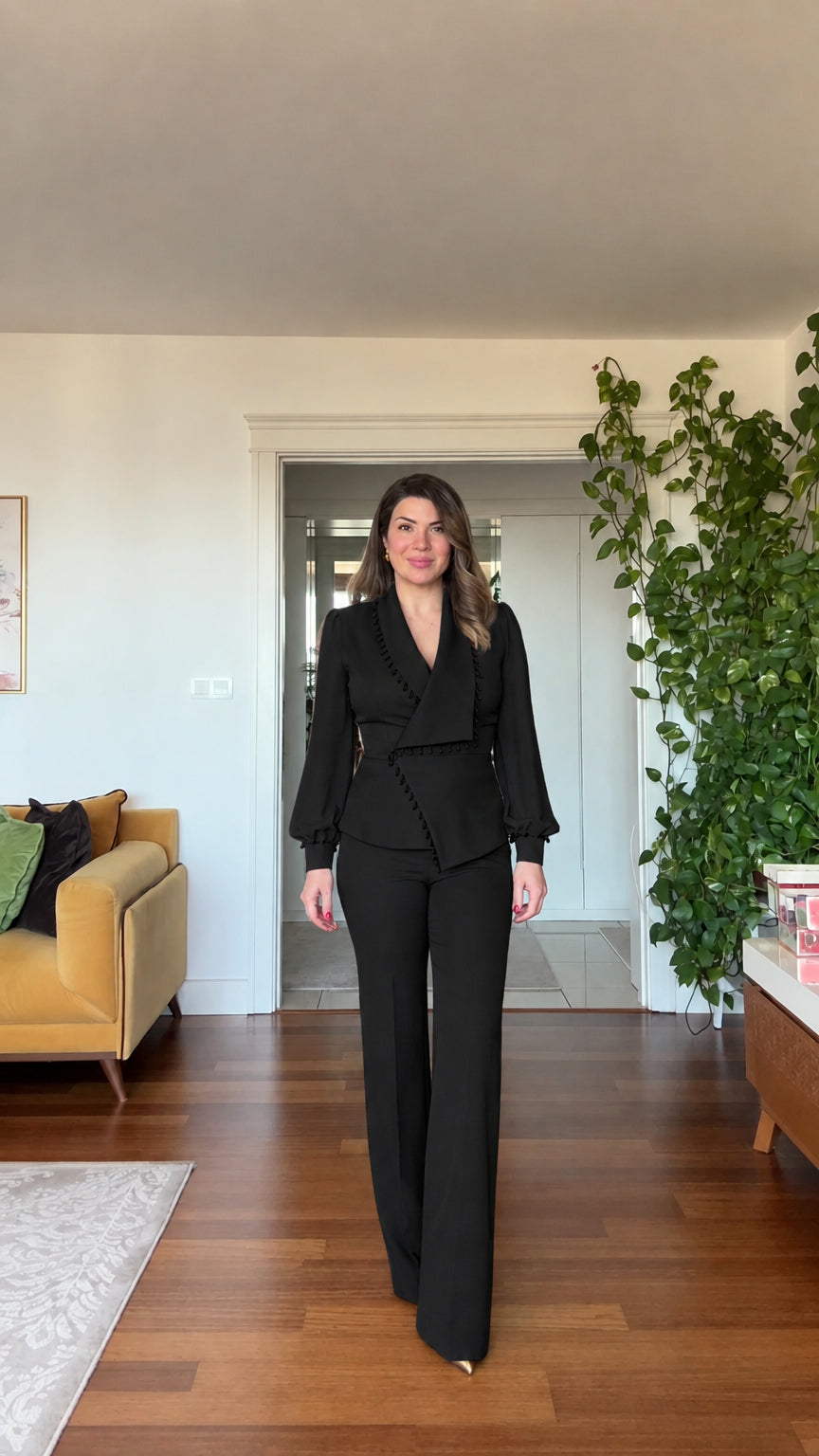 Full-length front view of woman wearing black beaded blazer and wide leg pants suit set