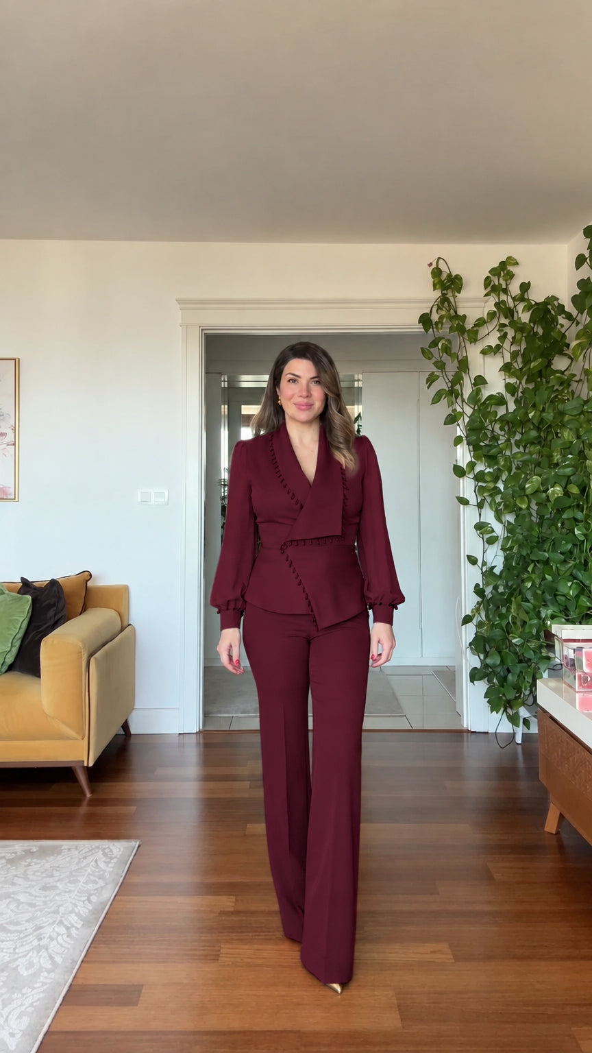 Full-length front view of woman wearing burgundy wine beaded blazer and wide leg pants suit set