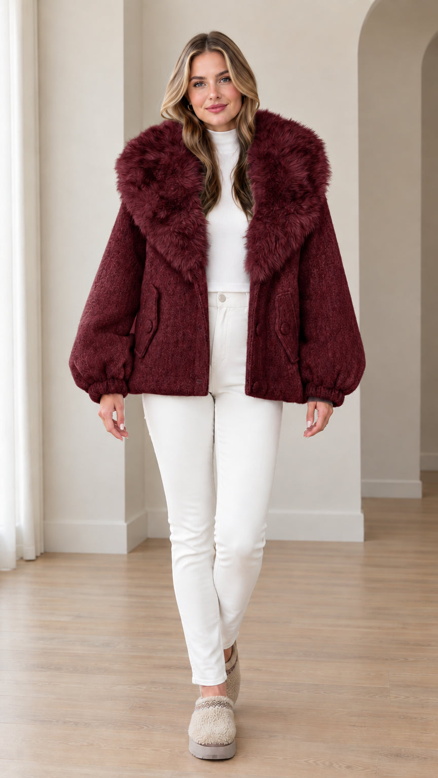 Front view of woman wearing deep burgundy wine faux fur hooded jacket